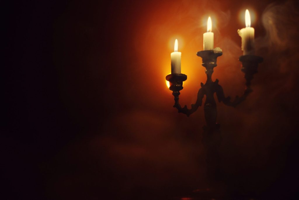 a couple of candles that are on a wall